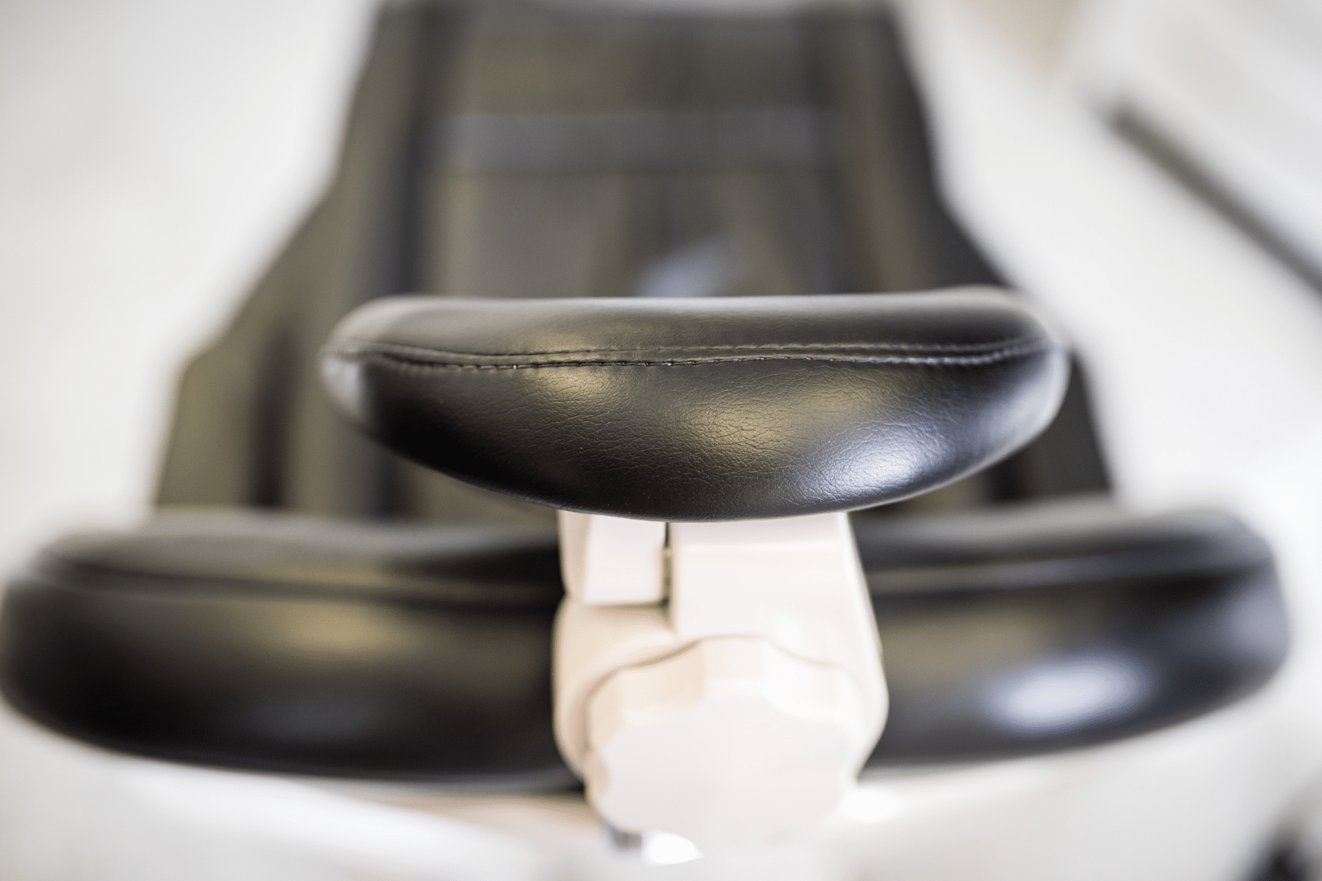 Gum Contouring - Hampshire Dentists Pain Free Dentist in Southampton Detailed close-up of a black and white dental chair