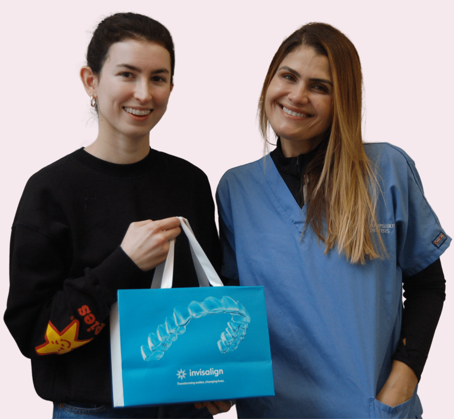 Invisalign - Hampshire Dentists Pain Free Dentist in Southampton Dr Joanna Binato standing with patient holder her Invisalign gift bag ready to start her Invisalign treatment