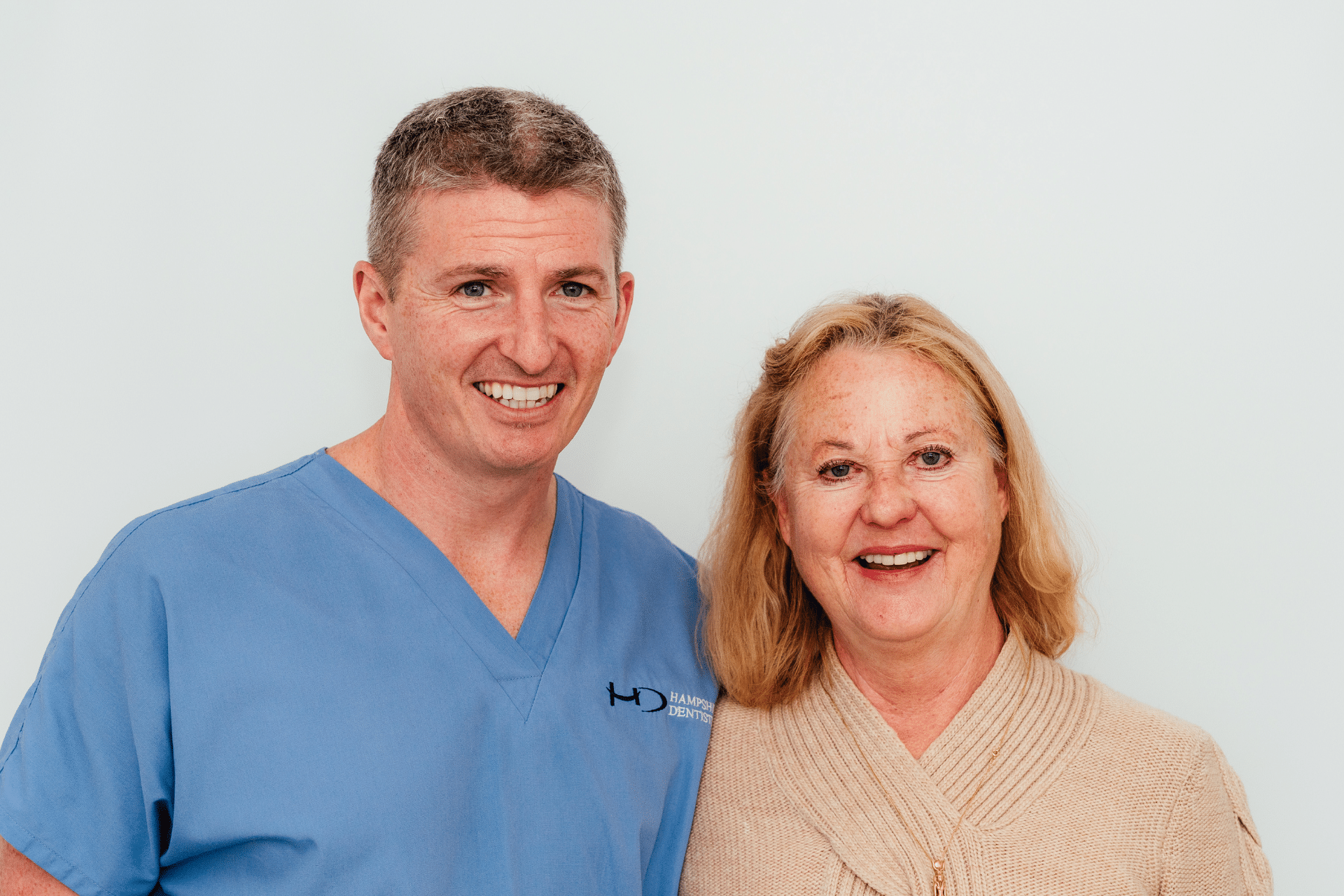 Full mouth implants (All on 4) - Hampshire Dentists Pain Free Dentist in Southampton Dr. Robin Hanna and a patient, stand together, showing supportive Hampshire Dentists care