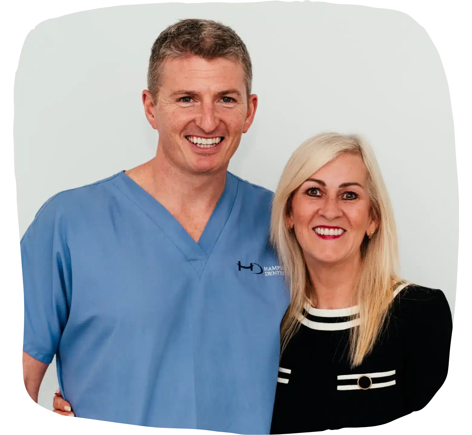 Dr Robin Hanna with happy implant patient, both standing together smiling brightly