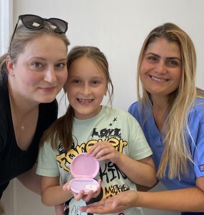 Children’s Braces - Hampshire Dentists Pain Free Dentist in Southampton Hannah and her mum with Specialist Orthodontist Dr Joanna Binato showing Invisalign First aligners in their case at the beginning of teeth straightening treatment